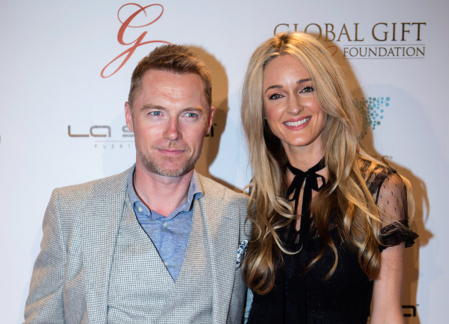 It's a family affair as Ronan and Storm step out with the kids for gift gala