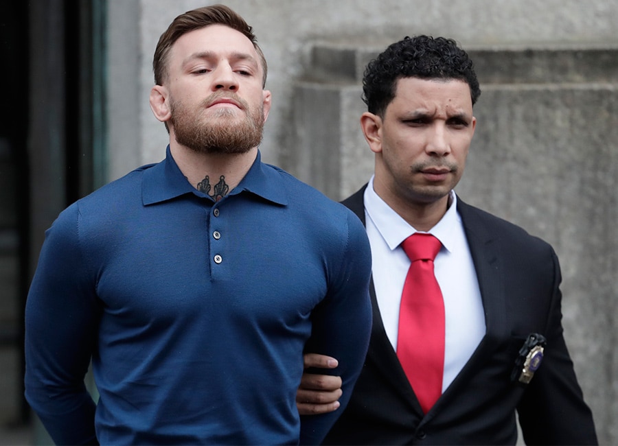 WATCH: Conor McGregor puts on brave face as he is handcuffed and led from police station