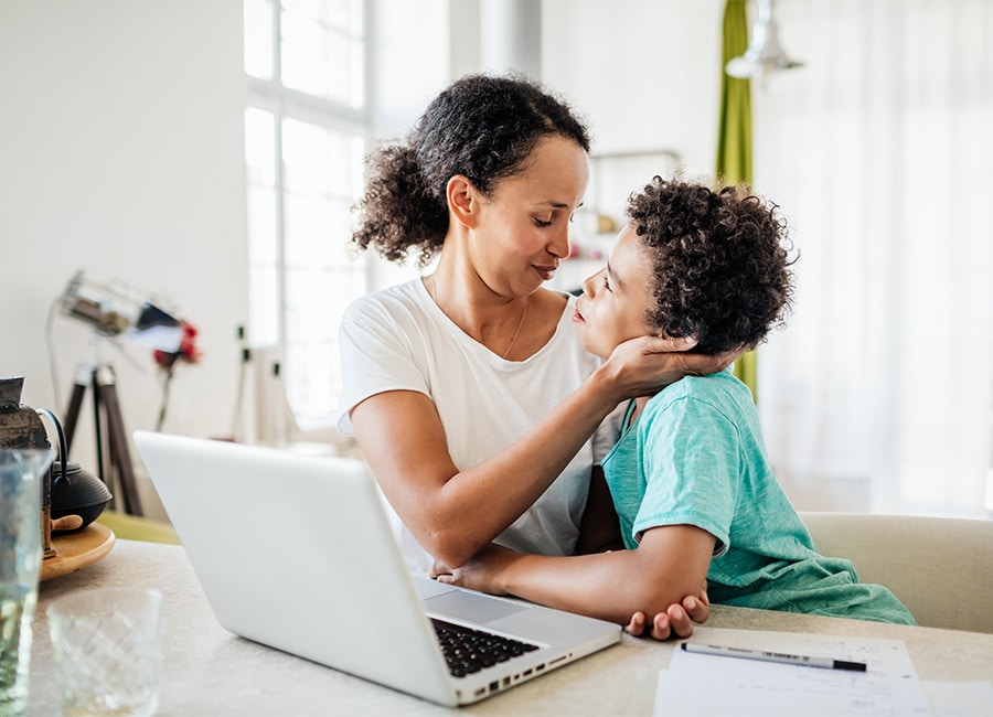 Mother working from home with child