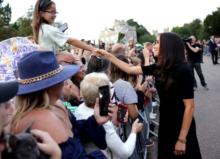 Meghan is embraced by young women as she returns to royal life at Windsor Castle