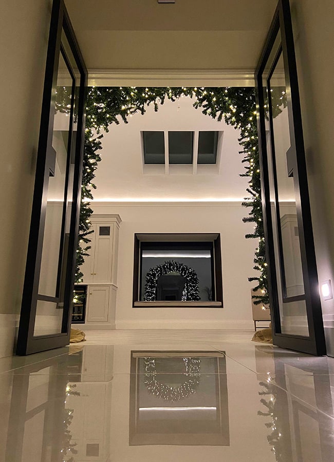 A Christmas tree arch around a door