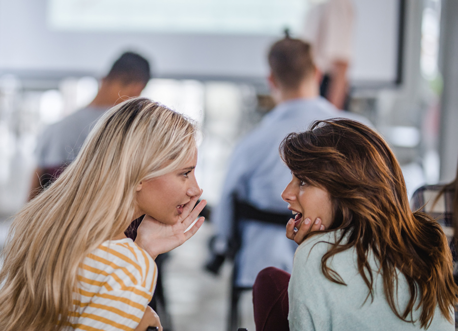 colleagues gossiping in office