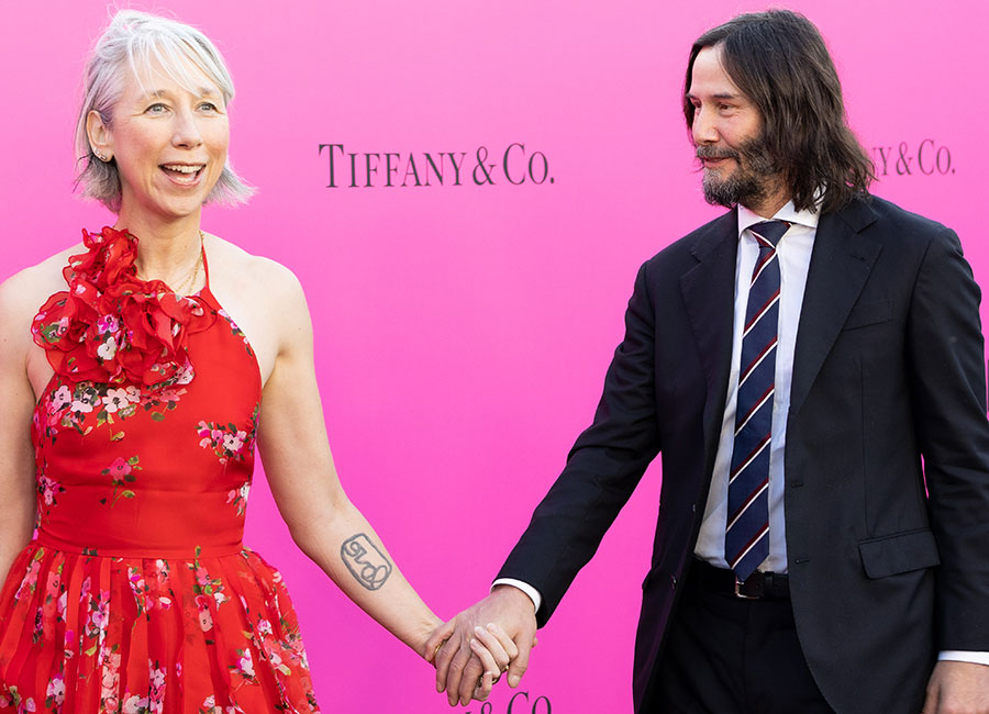 Mwah! Keanu Reeves and his girlfriend put on a loved-up show on the red carpet