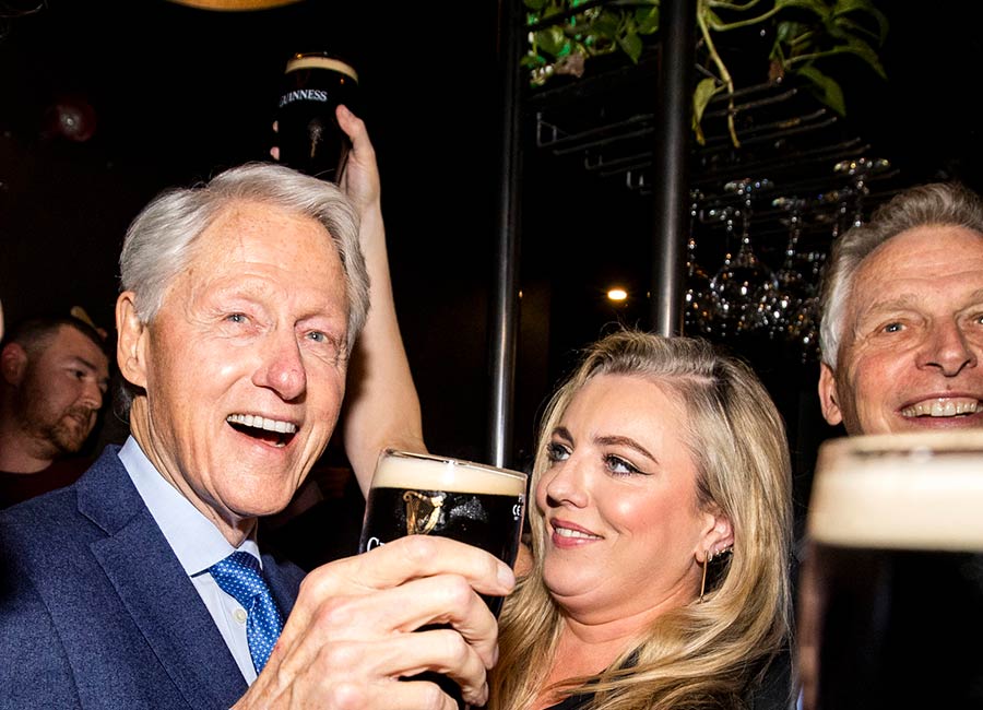 Bill Clinton is all smiles as he sips on a pint of Guinness in Derry