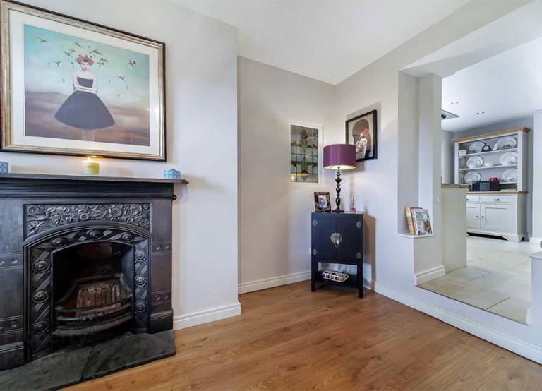 MILFORD ROAD, Ramelton, Bridgend F92 P9K6 €195,000 interior sitting living room carpet fireplace chairs table wooden decor window view painting portraits