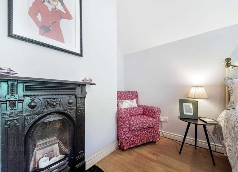 MILFORD ROAD, Ramelton, Bridgend F92 P9K6 €195,000 interior bedroom bed and red sofa chair fireplace