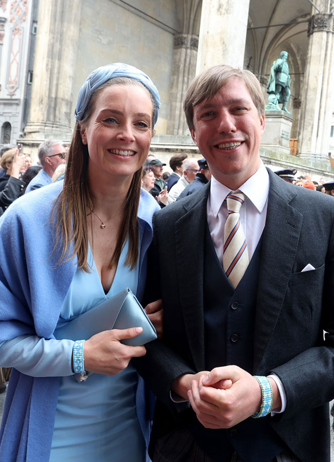 Louis Prince of Luxembourg and his companion stand in front of the Theatinerkirche after the church wedding of Ludwig Prince of Bavaria and Sophie-Alexandra Evekink