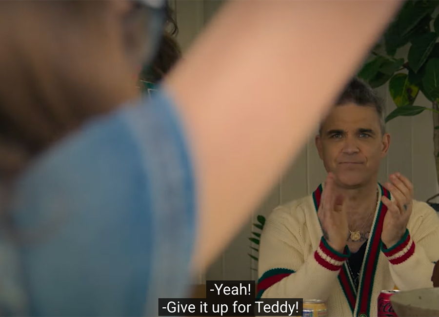 Robbie Williams' daughter Teddy sings to him. Pic: Netflix