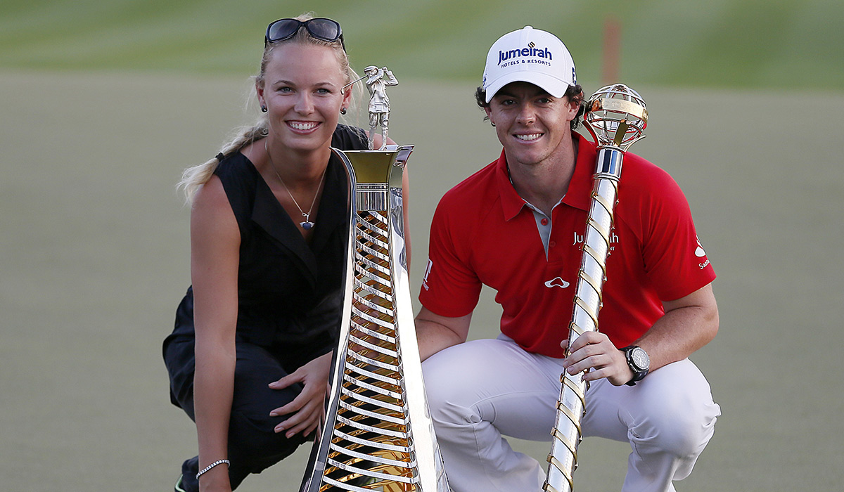 Northern Ireland's Rory McIlroy poses with his girlfriend, Denmark's tennis champion Caroline Wozniacki, after winning the DP World Tour golf Championship in the Gulf emirate of Dubai on November 25, 2012. McIlroy responded in magnificent fashion to Justin Rose's course record round of 10-under par 62 by making five birdies in his last five holes to win the Championships. AFP PHOTO / KARIM SAHIB (Photo credit should read KARIM SAHIB/AFP via Getty Images)