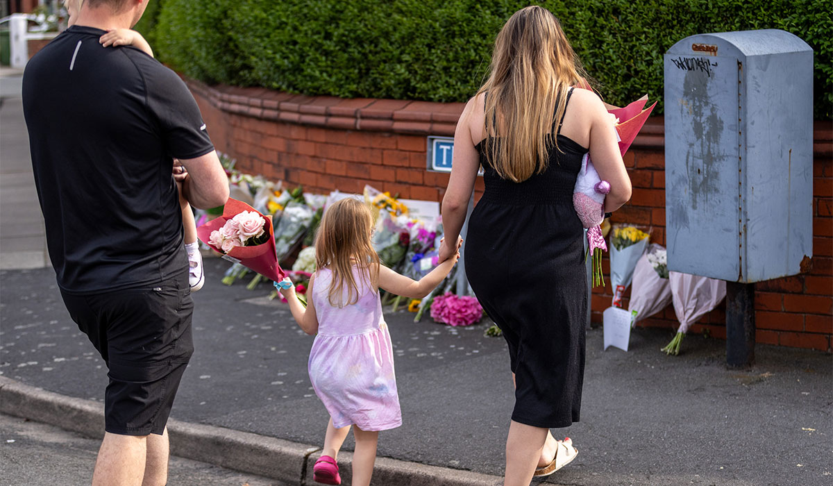 People leave flowers near the scene in Hart Street, Southport, where two children died and nine were injured in a 'ferocious' knife attack during a Taylor Swift event at a dance school on Monday. Pic: James Speakman/PA Wire