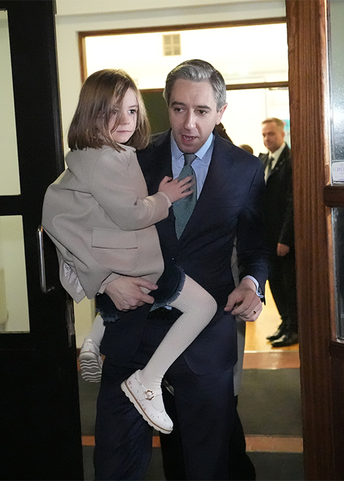 Taoiseach and Fine Gael leader Simon Harris carries his five-year-old daughter Saoirse after casting his vote at Delgany National School, County Wicklow. Pic: Niall Carson/PA Wire