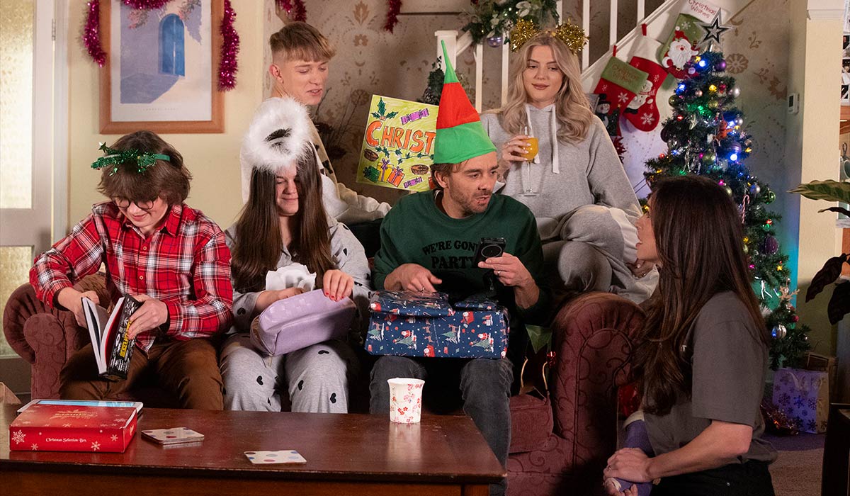 When opening Christmas presents, David Platt [JULIA GOULDING] becomes suspicious of Shona Platt [JULIA GOULDING] when he doesn't unwrap the aftershave he found in Shona's bag. Pic: ITV