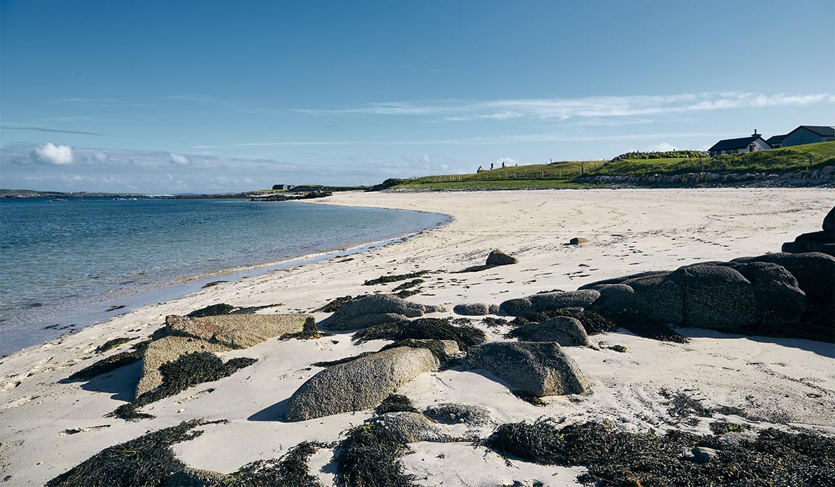 A landscape of the Omey Island surrounded by the sea under the sunlight and a blue sky in Ireland. Pic: Shutterstock
