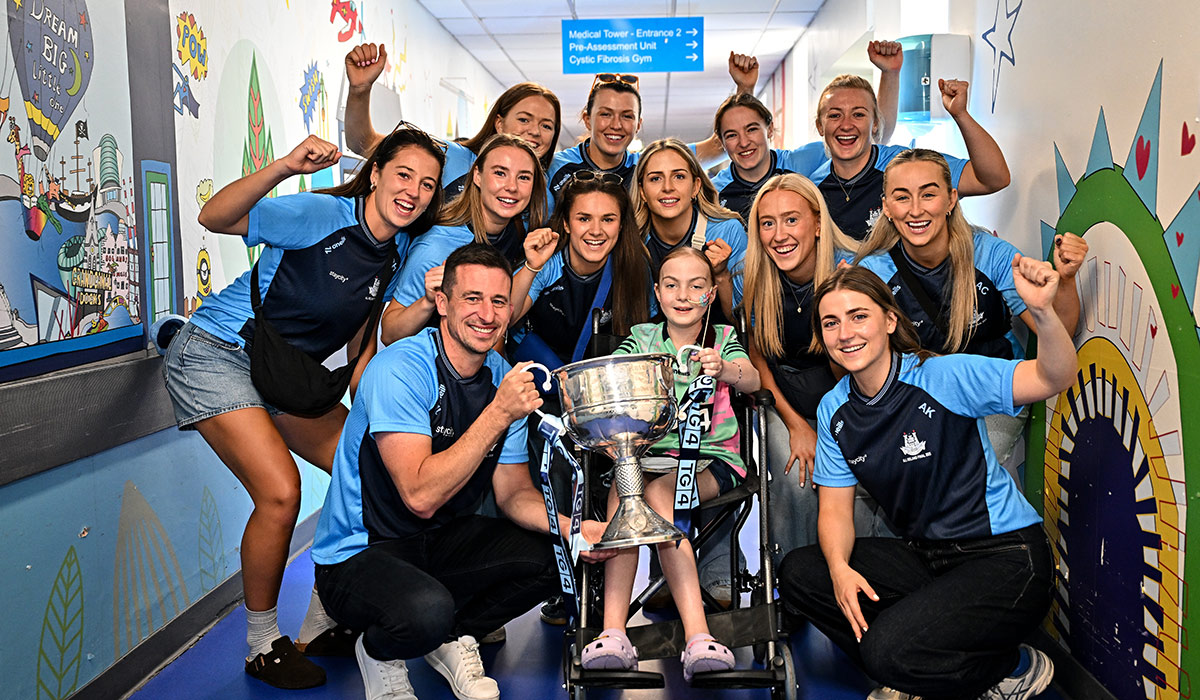 TG4 All-Ireland Ladies Senior Football Champions Dublin pictured with the Brendan Martin Cup and Zoe Moore, aged 9, from Ballinteer Dublin, neice of Joint manager Derek Murray, during a visit by the players to Children's Health Ireland at Crumlin, Dublin. Pic: Sam Barnes/Sportsfile