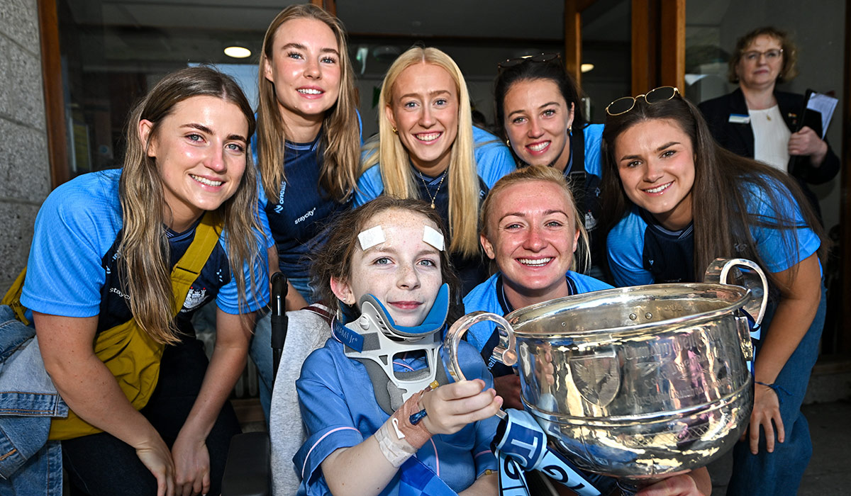 TG4 All-Ireland Ladies Senior Football Champions Dublin pictured with the Brendan Martin Cup and Nikki Hayes, aged 16, from Limerick, during a visit by the players to Children's Health Ireland at Crumlin, Dublin. Pic: Sam Barnes/Sportsfile
